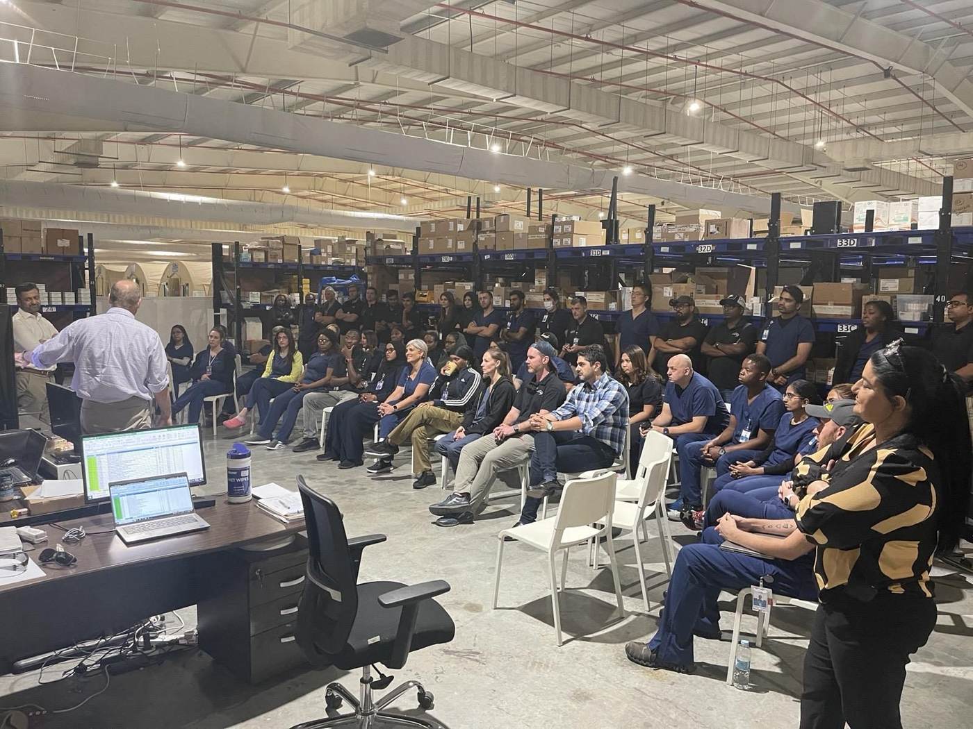 Warehouse team gathered for an operational briefing